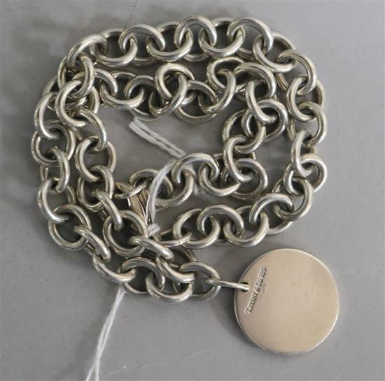 A modern Tiffany & Co silver disc pendant on a silver chain, pendant 23mm.